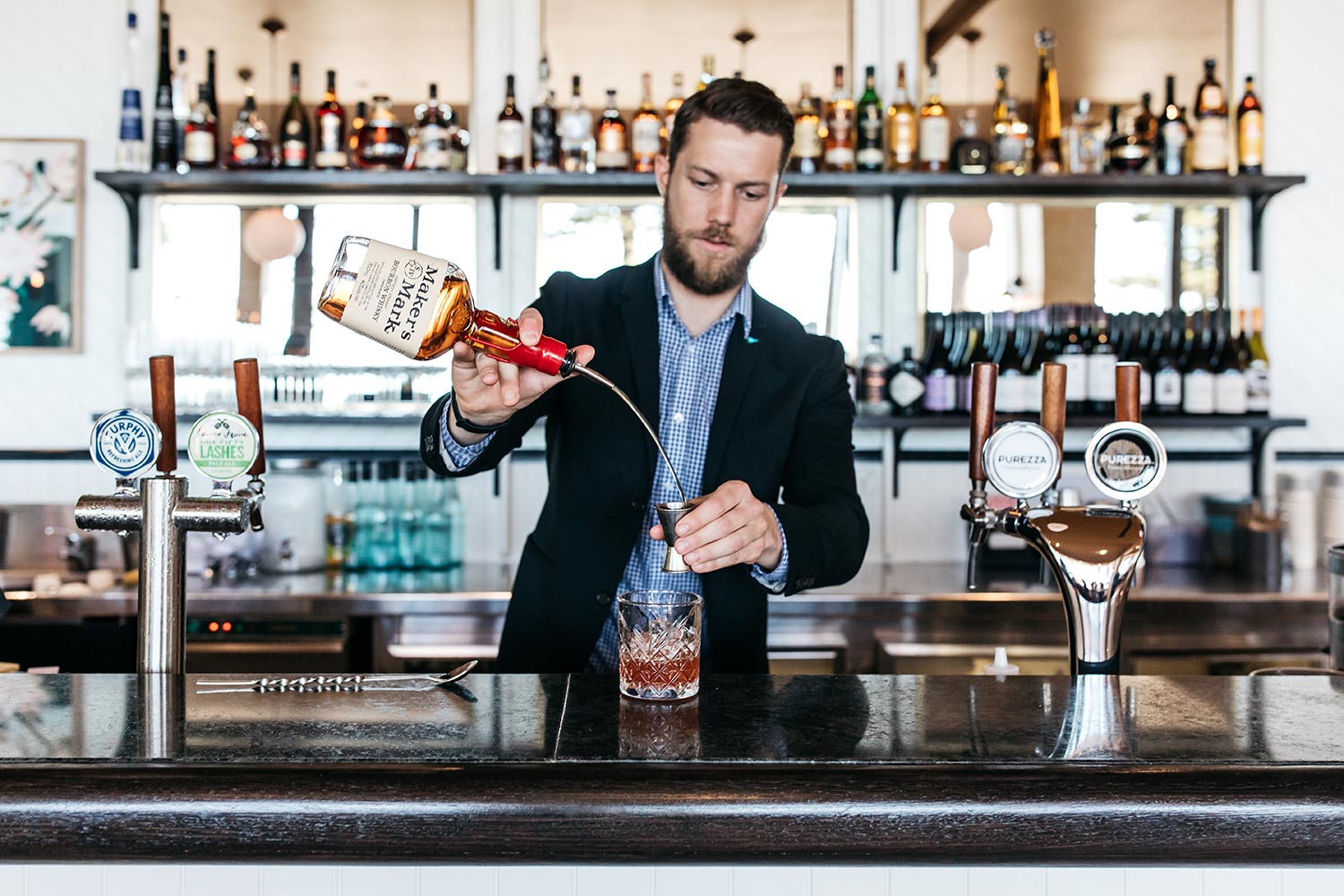 Bistro Manly restaurant - barman at bar preparing cocktail